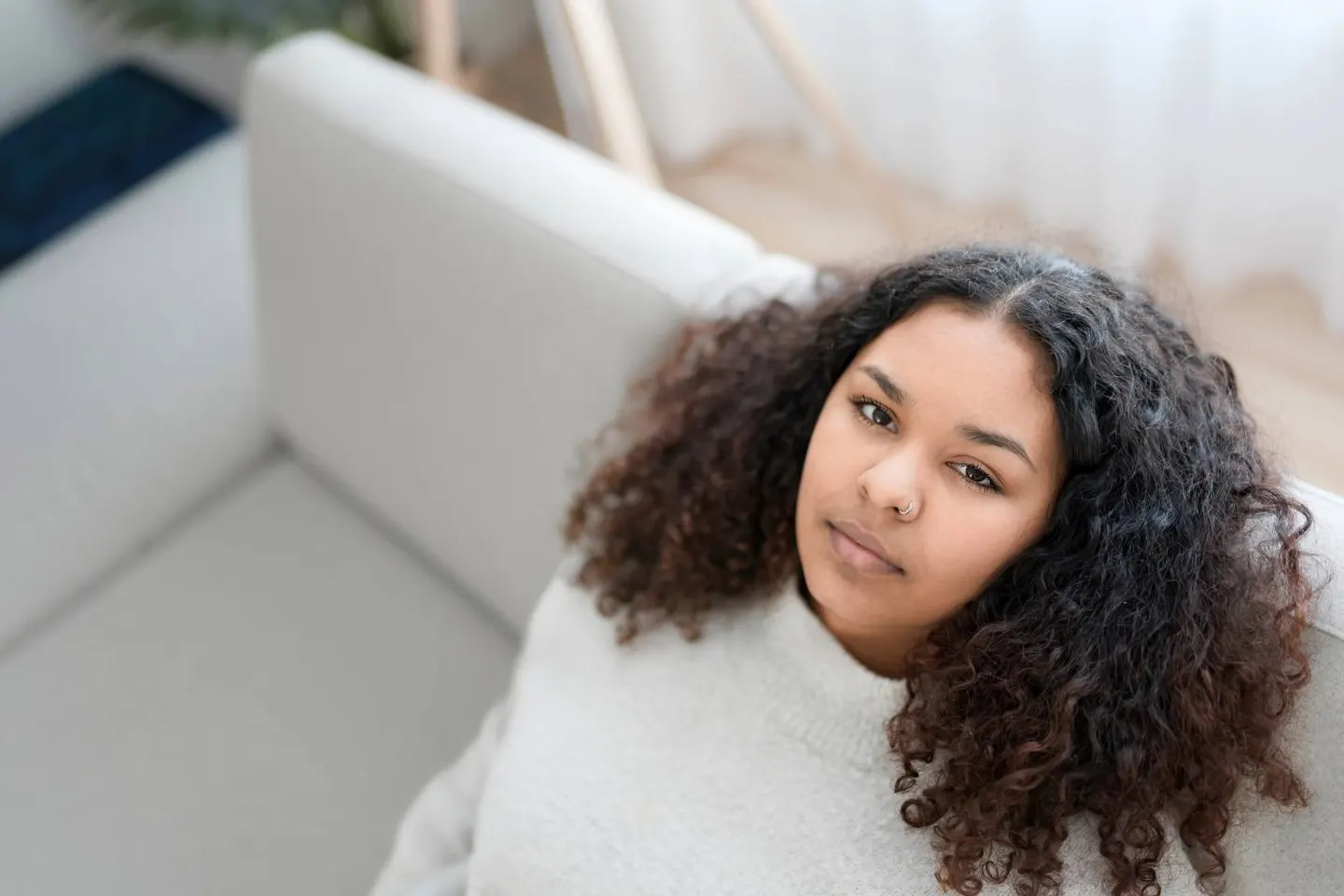 A young woman looking upward with a hopeful expression