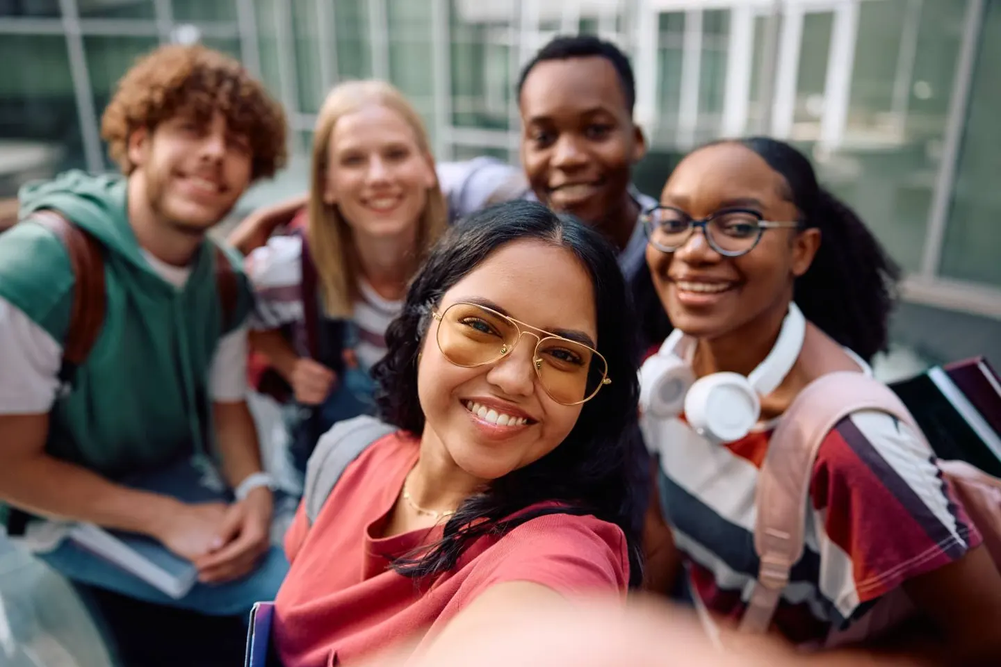 A group of smiling students taking a selfie together